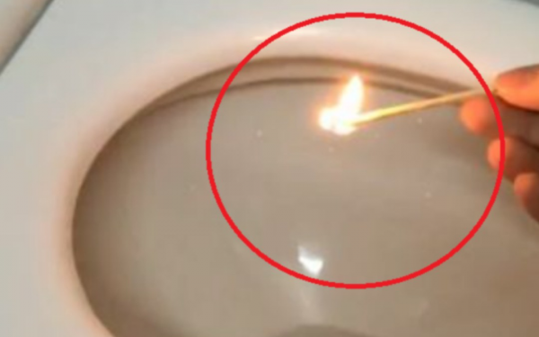 Dropping a burning match into the toilet